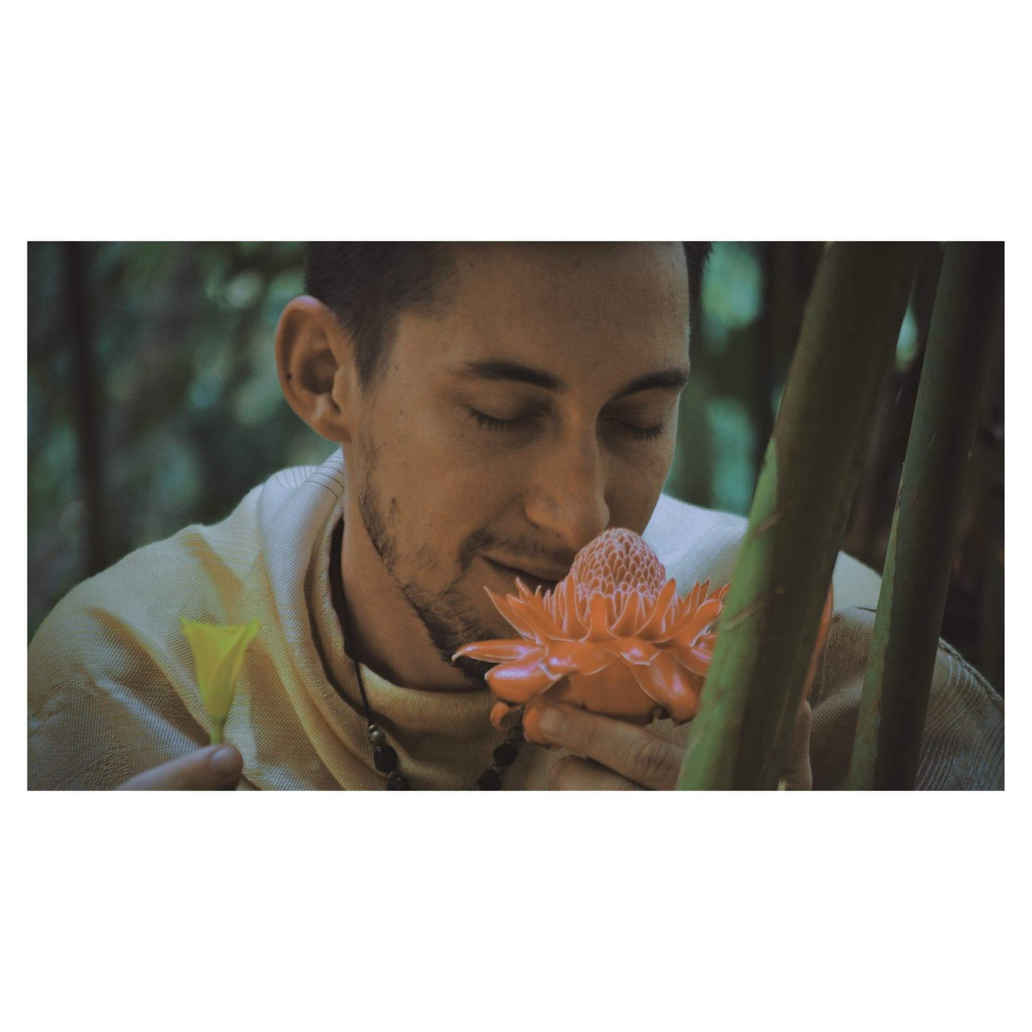 Smelling a flower among greenery